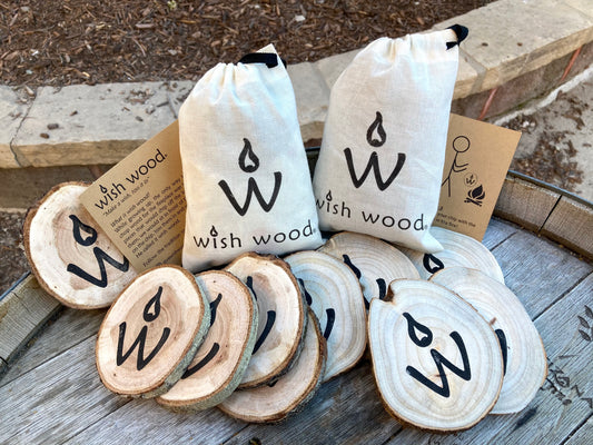 <img src="bag-wishes-gift-wish-wood-camping_jpg”  alt="friends getting ready to make their wishes for their camping trip - wish wood - for making memories and experiences"/>