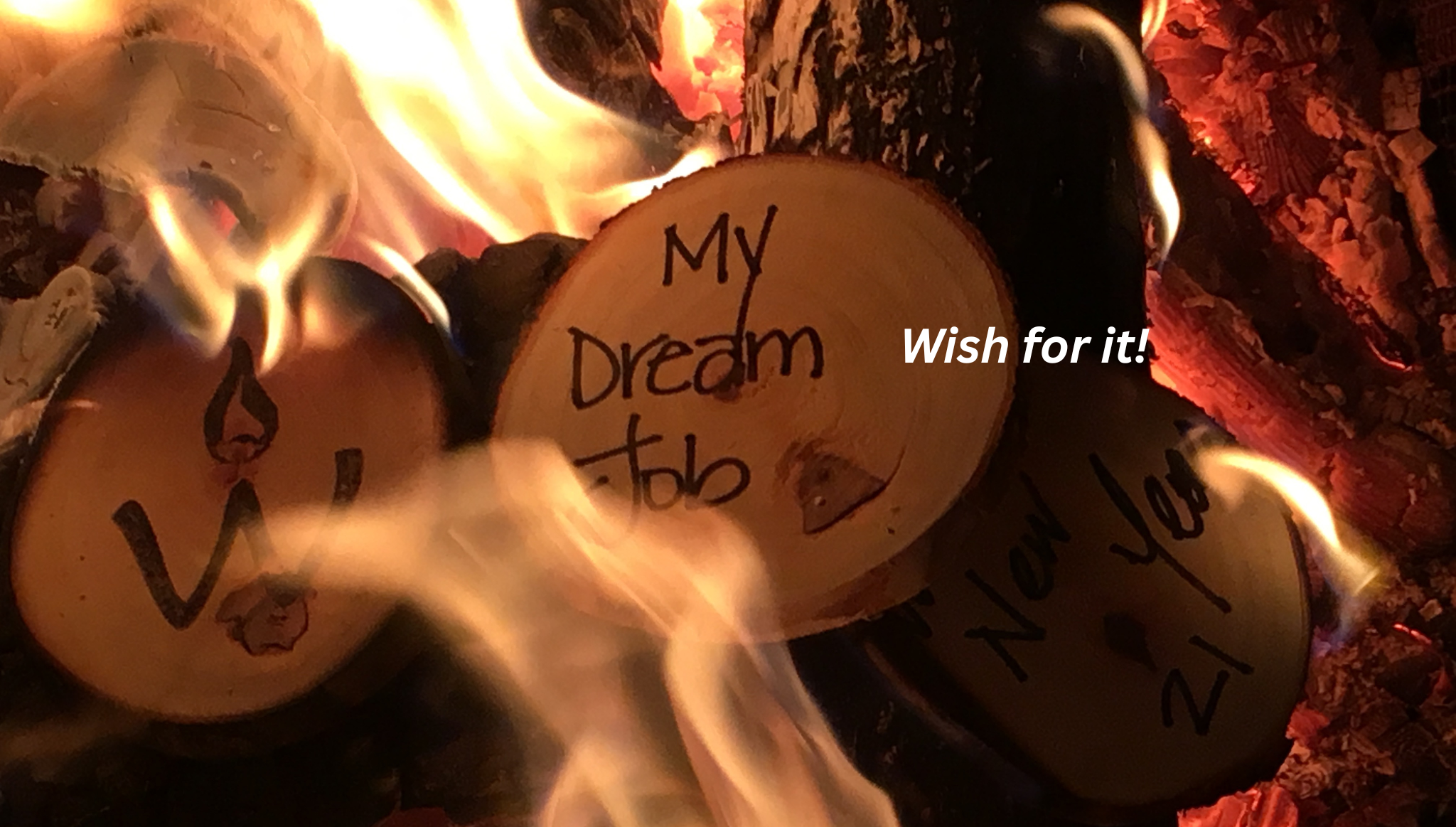 Wooden discs with engraved text over a fire